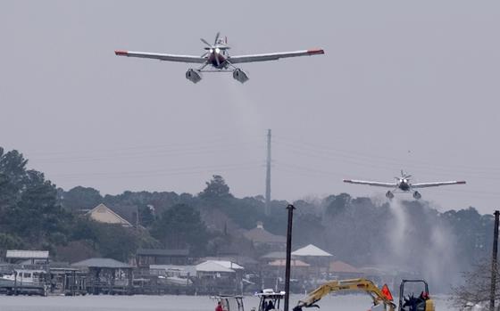 Planes fill bladders with water from the Intracoastal Waterway.