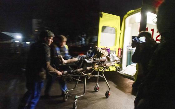 Russian Emergency paramedics roll a stretcher with a resident of an apartment building damaged after shelling by the Ukrainian side into an ambulance in Kursk, Russia, Sunday, Aug. 11, 2024. (AP Photo)