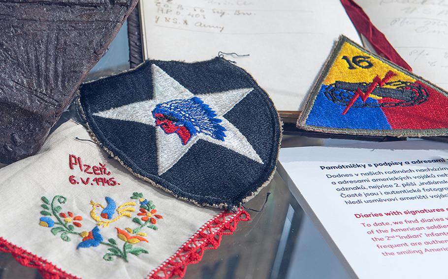 A 2nd Infantry Division patch, center, is among several donations to the Patton Memorial Pilsen in the Czech Republic.