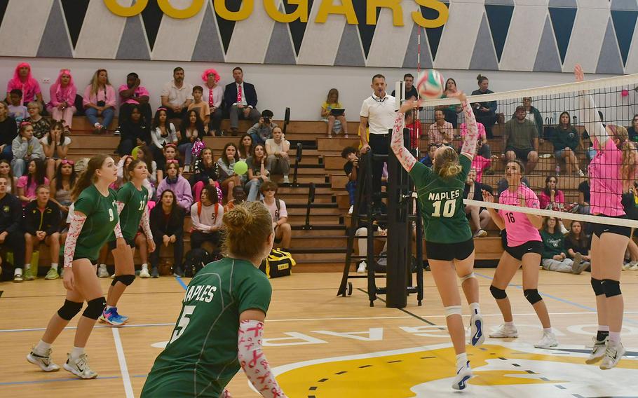 Naples' Gracie Grannis set the ball for her teammate Emma Heavy during the second set of the match between the Naples Wildcats and Vicenza  on Oct. 13, 2023. 