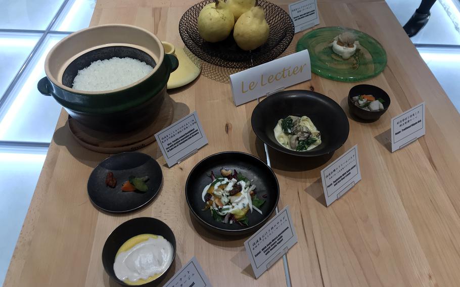 Dishes of various food on a wooden table.