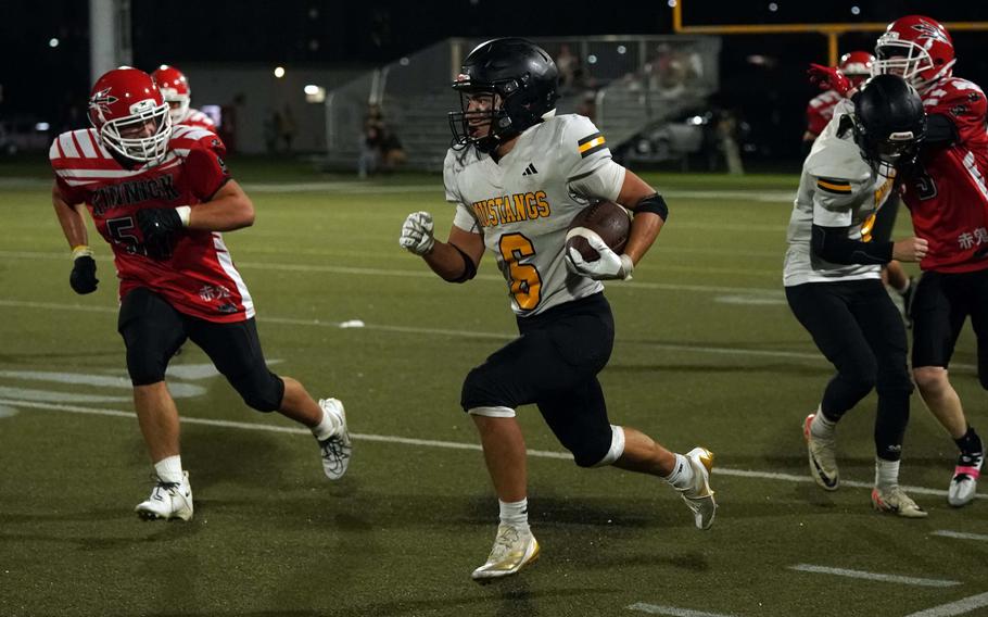 ASIJ’s Micah Eickbash  evades the tackle by Kinnick’s Maximus Cornelison.