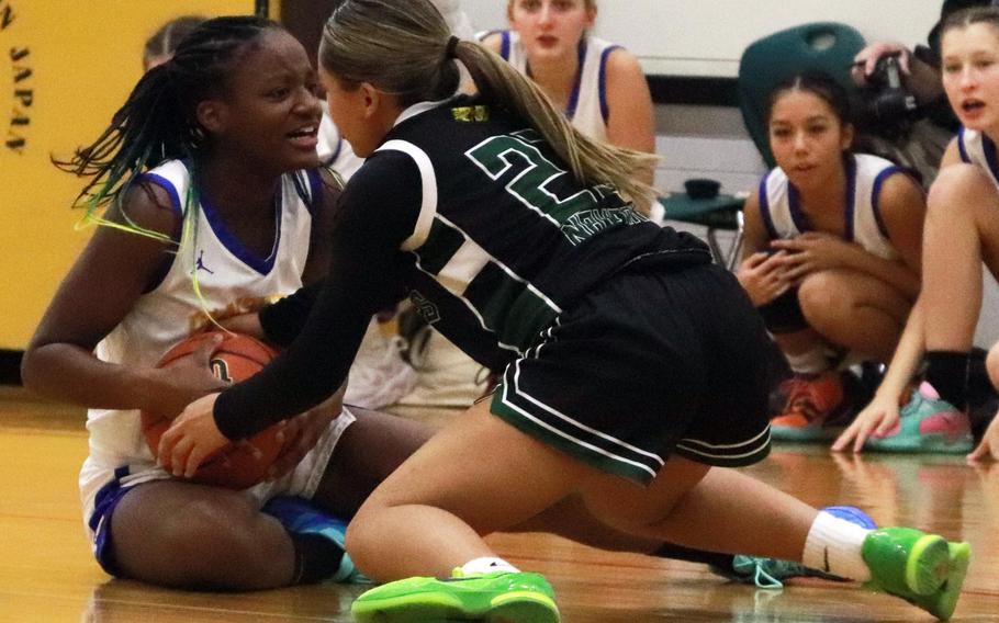 Beverly Gardner and Mylie Navarro struggle for the ball.