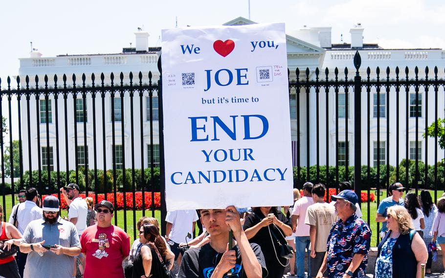 Mateo Zavala, 14, holds up a sign outside the White House on Wednesday, July 3, 3034, urging President Biden not to seek reelection. 