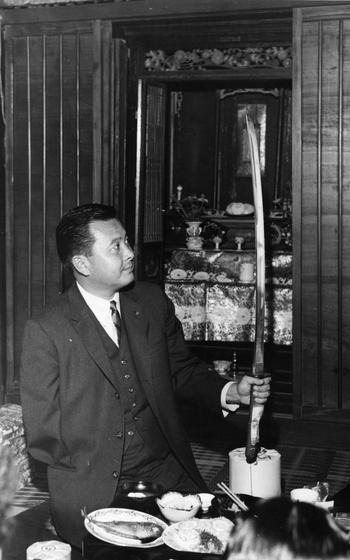 Rep. Daniel K. Inouye (D-Hawaii)  admires the Samurai sword gifted to him by Yokoyama’s villagers. Congressman Inouye visited the mountain village of Yokoyama — the birthplace of his father and where some of his uncles and cousins still live. During his 3½-hour tour, he visited his ancestral cemetery and had lunch with some of his relatives, during which he received the sword.