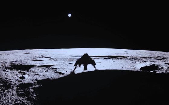 The surface of the moon with the Earth and a black sky in the background.