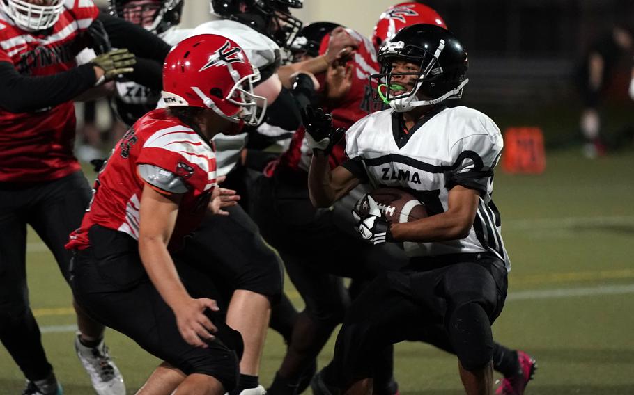 Zama's Yeriel Padin gets bottled up by Nile C. Kinnick's Jacob Bojorquiz.