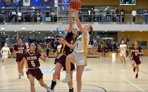 Stuttgart's Eve Henry shoots against Vilseck's Willa Greenwood in the girls Division I final at the DODEA-Europe basketball championships in Wiesbaden, Germany, Feb. 15, 2025. Stuttgart took the title with a 43-35 win over the Falcons.