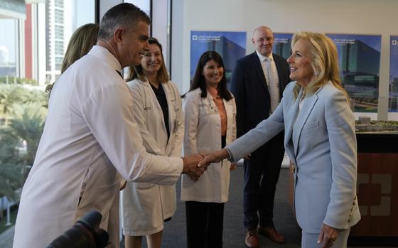 First lady Jill Biden, right, meets medical staff at Cleveland Clinic in Abu Dhabi, United Arab Emirates, Thursday, Dec. 5, 2024. (AP Photo/Altaf Qadri)