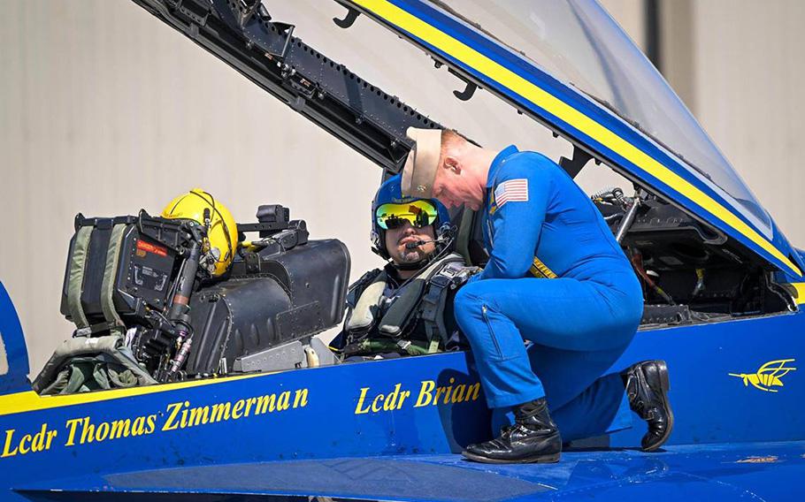 Navy pilot Lt. Cmdr. Thomas Zimmerman speaks with Erik Erazo, who was buckled in for a flight on the Blue Angels jet on Wednesday, Aug. 16, 2023, at New Century AirCenter in Gardner, Kansas. Erazo, a lowrider bike club founder selected as the Key Influencer for the 2023 Garmin KC Air Show, was honored with a flight in an F/A 18 Super Hornet. “I only passed out once,” said Earzo, who briefly passed out when the aircraft hit 7 Gs.