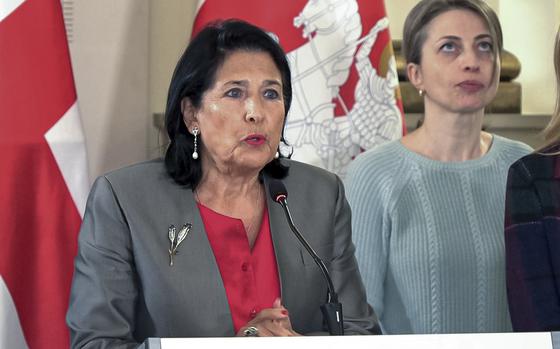 In this photo taken from video, Georgian President Salome Zourabichvili, left, speaks to the media as speaks to the media as and Nana Malashkhia, who leads the Coalition for Change parliament list, right, stands near, after the parliamentary election in Tbilisi, Georgia, on Sunday, Oct. 27, 2024. (AP Photo/Kostya Manenkov)