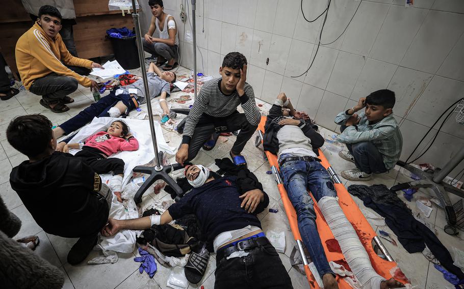 Injured Palestinians arrive at Nasser Medical Hospital on Dec. 5, 2023, after a UNRWA school housing displaced people in Khan Younis was targeted.