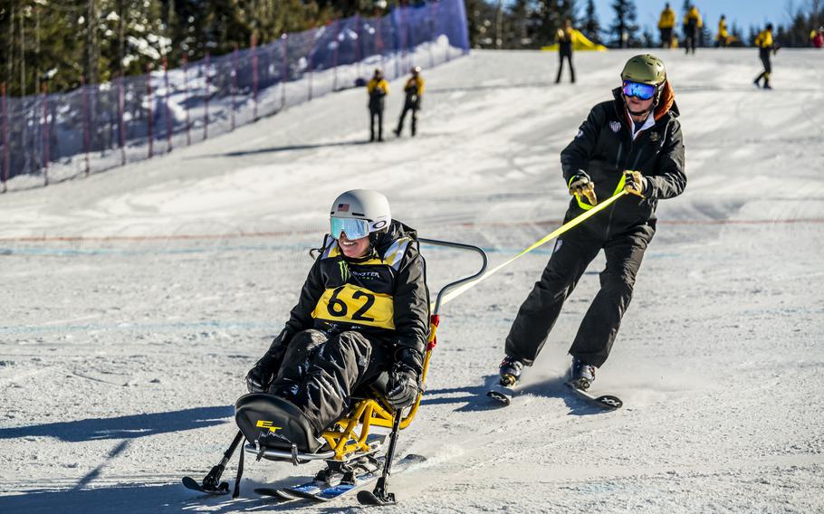 A competitor competes in the adaptive skiing event