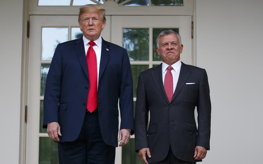 President Donald Trump stands with Jordan’s King Abdullah II at the White House.