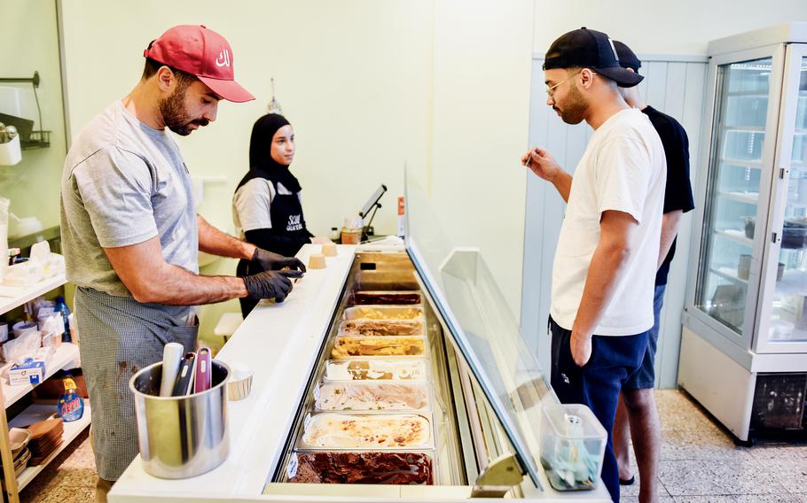 Customers select ice cream at a shop in Bahrain.