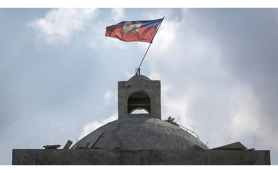 The flag flies atop the Catholic Church in Haiti, rebuilt after it was destroyed in the 2010 earthquake. 