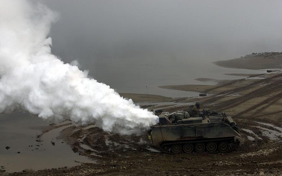 Gray and white smoke from the 4th Chemical Company