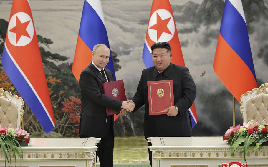 In this photo provided by the North Korean government, North Korean leader Kim Jong Un, right, and Russia's President Vladimir Putin shake hands after signing a comprehensive strategic partnership in Pyongyang, North Korea Wednesday, June 19, 2024.