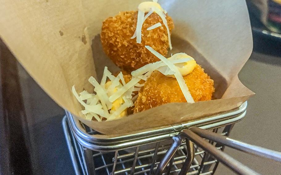 Mac and cheese bits from Mars Burger Co. are deep-fried clumps served in a wire basket.