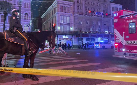 A mounted police officer arrives on Canal Street after a vehicle drove into a crowd earlier in New Orleans, Wednesday Jan. 1, 2025. (AP Photo/Kevin McGill)