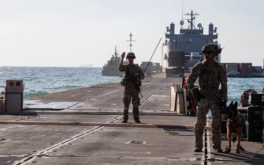 A U.S. soldier directs traffic across the pier and onto an Army vessel on June 22, 2024. The temporary pier, part of the Joint Logistics Over-the-Shore capability, was used to deliver humanitarian aid to Gaza.