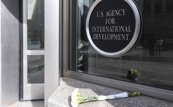 A bouquet of white flowers placed outside the headquarters of the United States Agency for International Development, or USAID, in Washington.