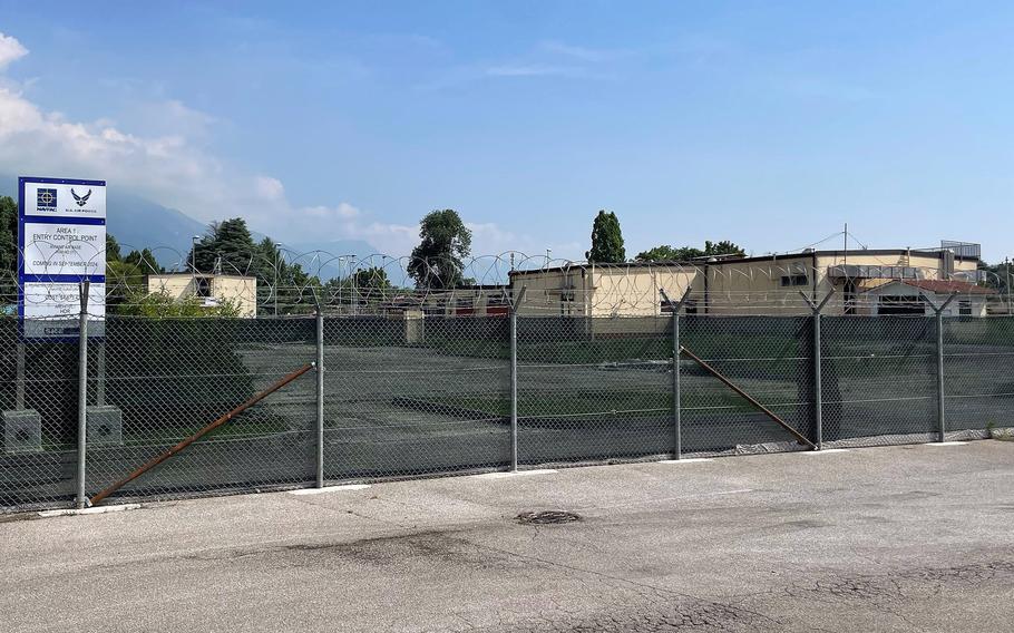 Construction fencing and barbed wire surrounds the former community center at Aviano Air Base Area 1 on June 18, 2024. Demolition and a new entry control point have been delayed due to the need for asbestos mitigation.