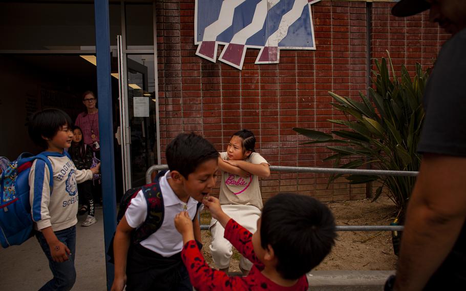 Muhan waits outside the school while her father attempts to register her. She was turned away on her first day of school because her forms had not been processed. Lei says he regrets what Muhan saw her parents go through, including their struggles once they reached the United States. “My child has suffered so much along the way. I think in her heart, it’s a perfect lesson,” he said. “She will know how terrible it can be for a person without education.”