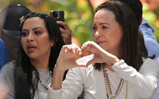 Venezuelan opposition leader Maria Corina Machado gestures to supporters next to opposition figure Delsa Solorzano during a rally in Caracas on Aug, 28, 2024. Venezuela's opposition supporters rallied on Aug. 28, a month after the disputed re-election of President Nicolas Maduro, who armored his cabinet with a strongman at the helm of law and order. (Juan Barreto/AFP/Getty Images/TNS)