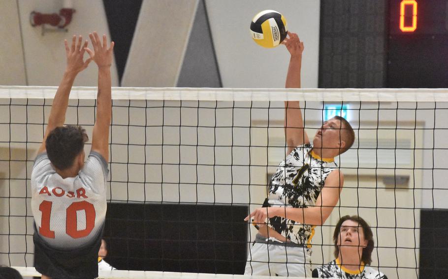 Vicenza’s Nicholas Morton hits the ball toward the block of American Overseas School of Rome’s Lorenzo De Nicola in the Cougars’ pool-play victory on the first day of the DODEA-Europe boys volleyball championships in Vicenza, Italy, on Thursday, Oct. 26, 2023.