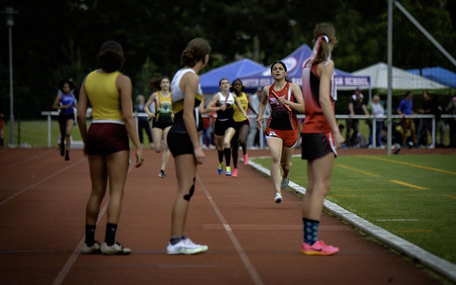 Kaiserslautern’s Katharina Storch, at right, waits to receive the baton from her teammate during the girls 1,600 meter sprint medley finals at the 2024 DODEA European Championships at Kaiserslautern High School in Kaiserslautern, Germany, on May 24, 2024. Kaiserslautern won with a time of 4:26.85.
