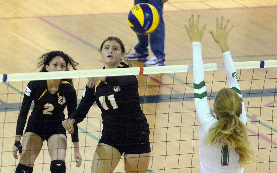Kadena's Presley Pearce spikes past Kubasaki's Emma Leggio during Tuesday's Okinawa volleyball match. The Dragons beat the Panthers in straight sets for the 10th time this season.