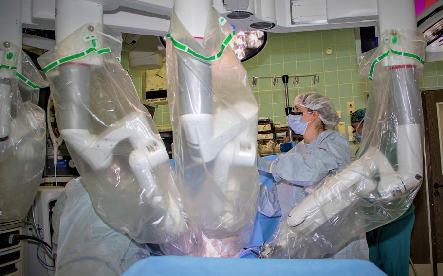 A staff member positions a robotic surgical system during an operation at Landstuhl Regional Medical Center, Germany, Jan. 12, 2022. The medical center recently increased access to care for surgical services to non-active duty patients. 