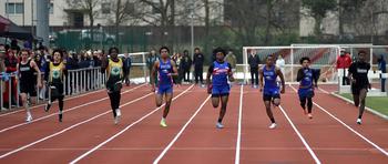 Competitors run in the 100-meter dash.