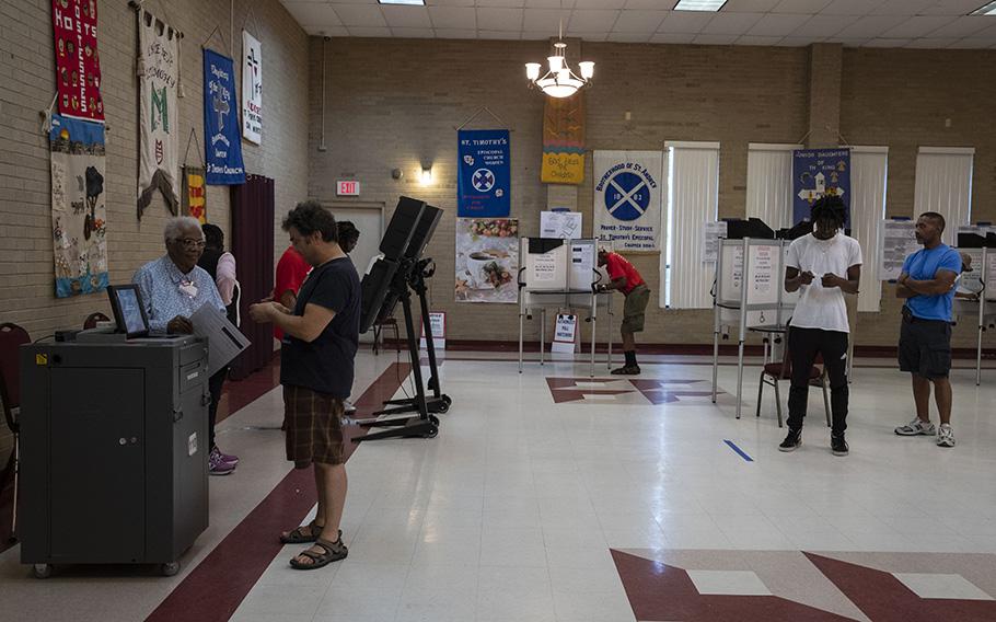 Voters cast their ballots at a voting site at St. Timothy’s Episcopal Church in D.C. in 2018. A group of voters and an anti-immigration group have filed suit to challenge the District’s new law allowing noncitizens the ability to vote in local elections. 