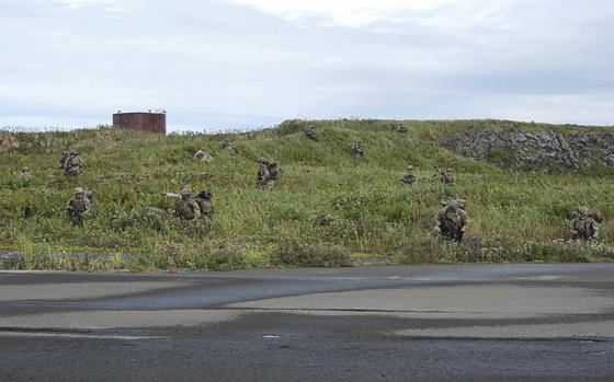 U.S. Army soldiers maneuver through the thick terrain of Shemya Island, Alaska, as part of a force projection operation to the remote island in the north Pacific Ocean on Sept. 13, 2024.