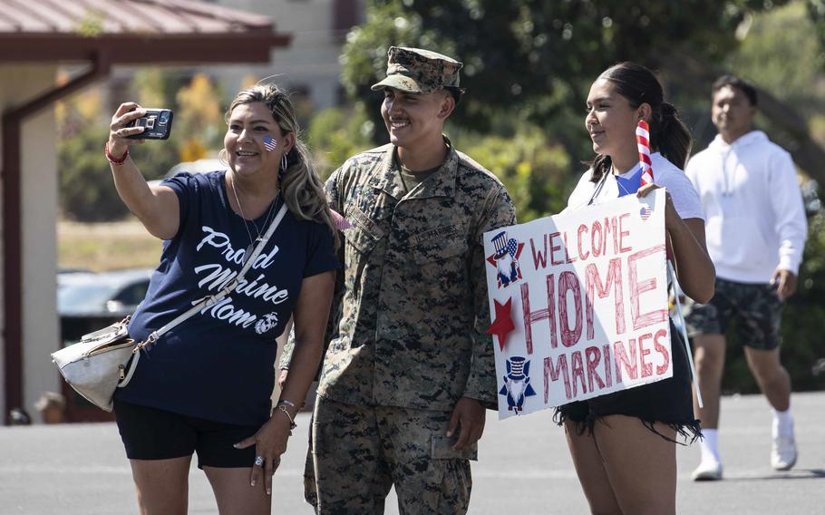 U.S. Marine Corps Cpl. Richard Monreal, a rifleman with Charlie Company, Battalion Landing Team 1/5, 15th Marine Expeditionary Unit, and a native of Riverside, Calif., poses for a photo with his mother and sister at Marine Corps Base Camp Pendleton, Calif., on Aug. 10, 2024, after returning from a deployment  