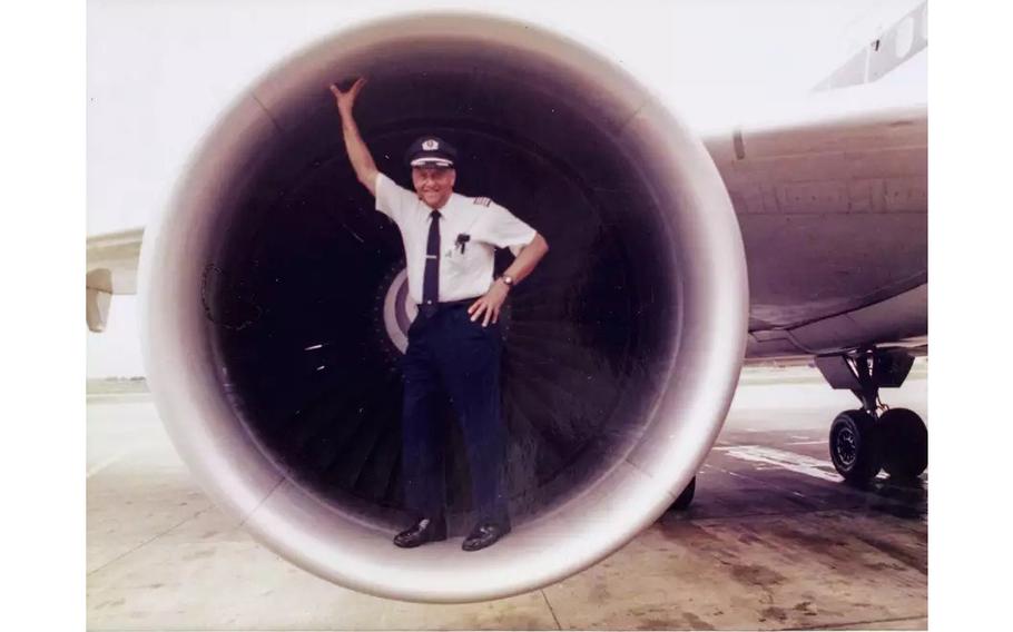 David Harris stands inside a jet engine.