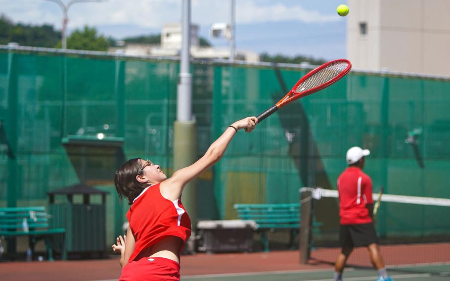 Nile C. Kinnick's Catherine Kerns serves during her 8-4 loss Friday against Robert D. Edgren's Kaitlyn Pasion in DODEA-Japan tennis openers.