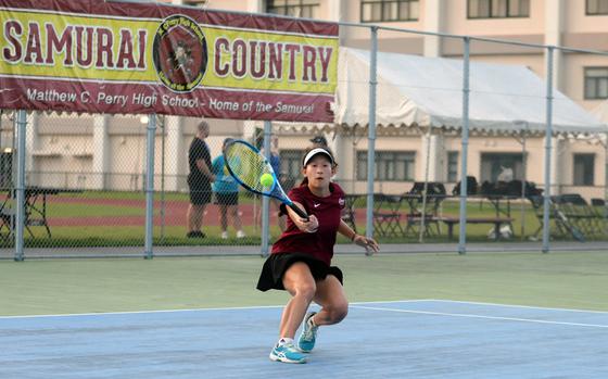 Under a banner of the Matthew C. Perry High School mascot, Sasha Malone returns a forehand against E.J. King's Miu Best, last year's runner-up, to reach the girls Division II finals in the Far East tennis tournament.