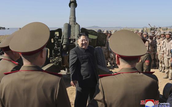 Kim Jong Un surrounded by North Korean Soldiers.