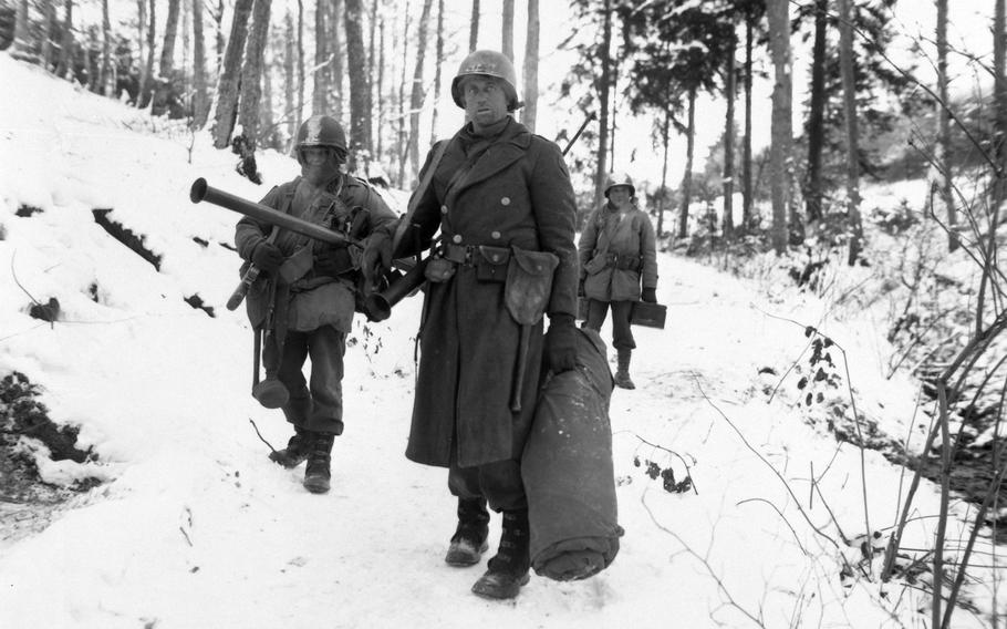 American engineers emerge from the woods and move out of defensive positions after fighting in the vicinity of Bastogne, Belgium, druing the Battle of the Bulge.