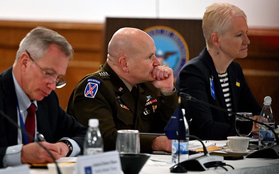 U.S. Army Gen. Christopher Cavoli rests his chin on his left hand as he listens. 