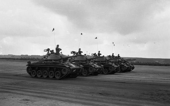 HED: Rolling tank salute, 1950

Grafenwoehr, Germany, June 3, 1950: Five tanks roll passed the review stand at Grafenwoehrs's parade grounds. The Big Red One - the Fighting First - celebrated the 33rd anniversary of its founding with a full-dress review on the huge Grafenwoehr parade ground. 

More than 20,000 soldiers marched past their commander, Maj. Gen. John E. Dahlquist in the 45 minute long parade.

Looking for Stars and Stripes’ historic coverage? Subscribe to Stars and Stripes’ historic newspaper archive! We have digitized our 1948-1999 European and Pacific editions, as well as several of our WWII editions and made them available online through https://starsandstripes.newspaperarchive.com/

META TAGS: 1st Infantry Division; Big Red One; U.S. Army; ceremony; parade; military history