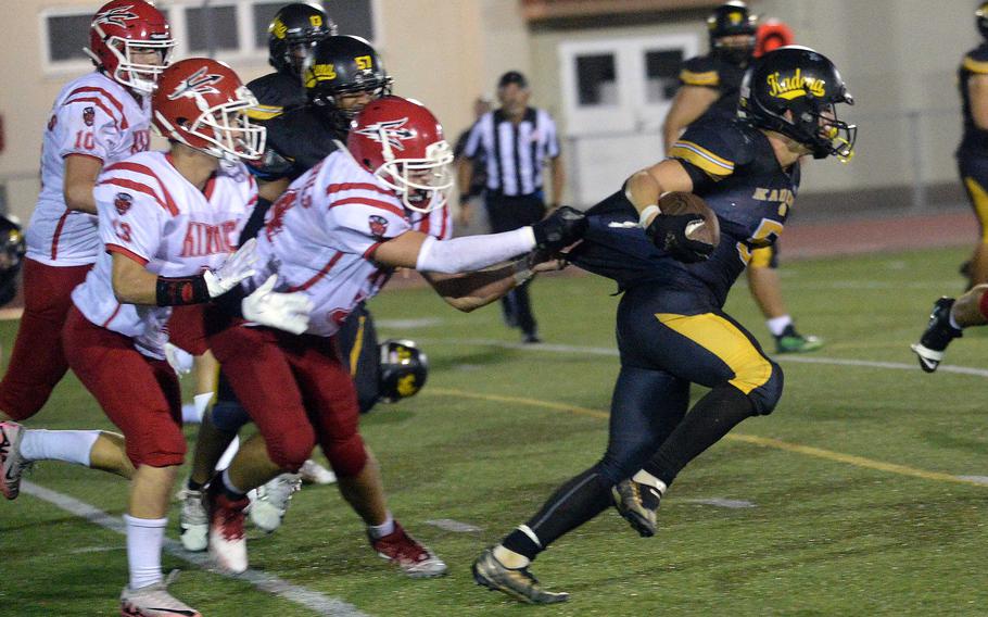 Ethan Ferch tries to free his jersey from the clutches of Kinnick defender Nathan DeWolfe. Ferch ran 2 yards for a third-quarter touchdown.