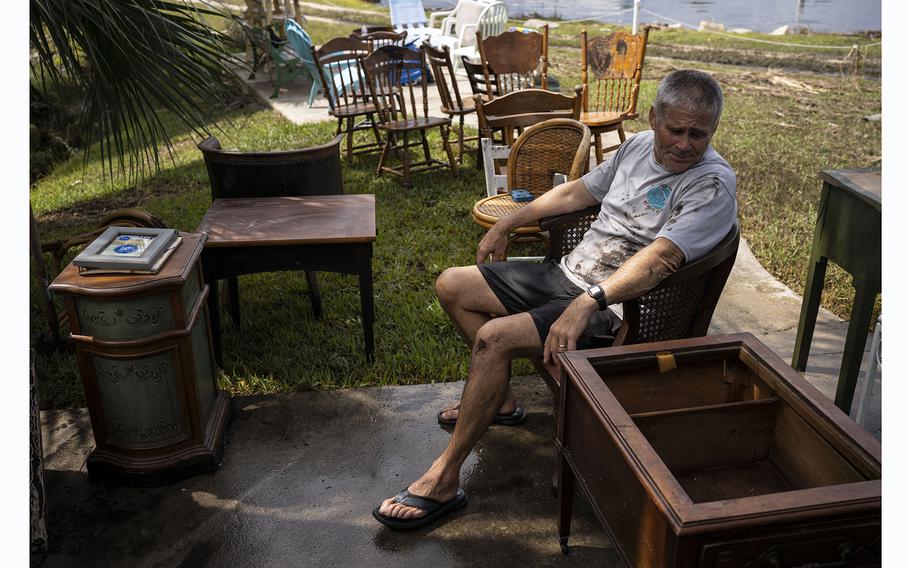 Skip Pattison, from Atlanta, takes a break from helping his mother, Bobbi, clean up her house in Steinhatchee, Fla., on Aug. 31, 2023.