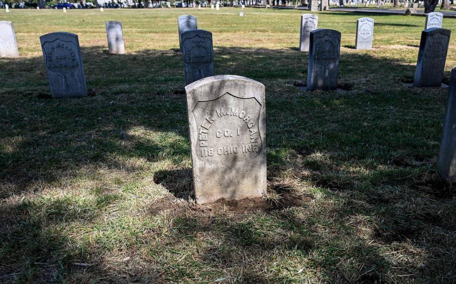 A veterans headstone is illuminated in the afternoon light at the Veterans Liberty Cemetery in Fresno on Friday, April 28, 2023.