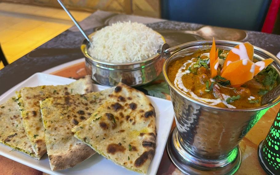 Lamb jalfrezi served with rice and paneer naan flatbread at Singh's Tandoori Indian Restaurant in Wiesbaden, Germany. The Indian curry has strong notes of garlic, ginger and various other spices.