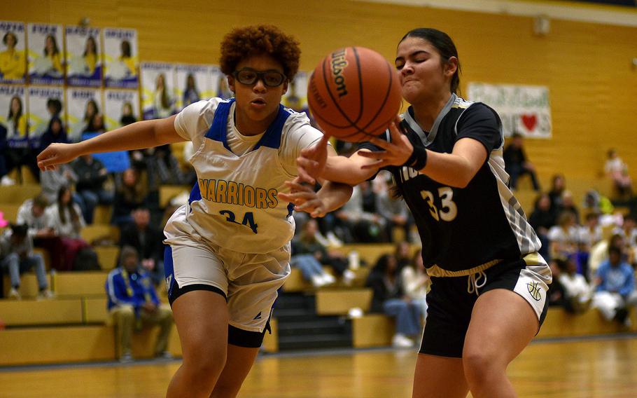 Keyoni Green and Emily Rodriguez battle for the ball.