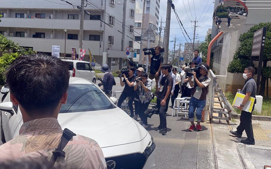 Japanese media attempt to photograph Senior Airman Brennon R.E. Washington outside Naha District Court on Okinawa, July 12, 2024.